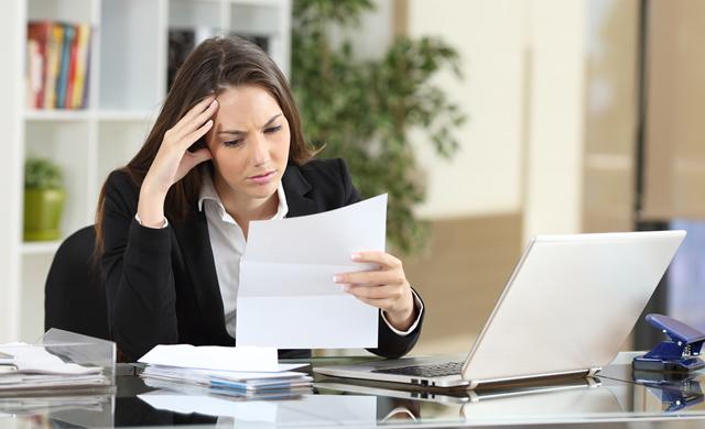 frustrated woman seated at desk